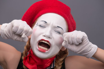 Waist-up portrait of young mime girl showing something