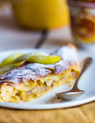 strudel dessert with pears on a white plate, . closeup