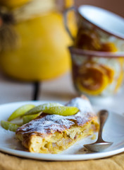 strudel dessert with pears on a white plate, .yellow napkin
