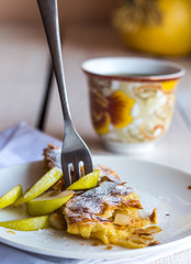 dessert apple strudel on a white plate, fork