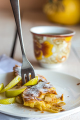 dessert apple strudel on a white plate, fork