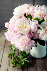 Bunch of peony flowers  in an enamel jar