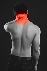 Rear view of a young man suffering from backache