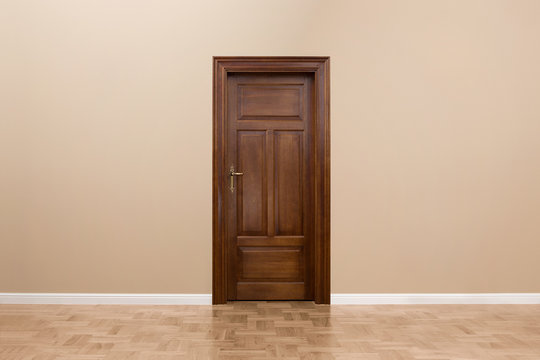 Wooden door in the empty room with copy space
