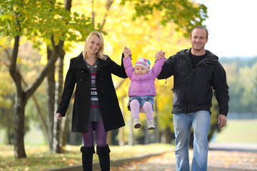 The happy family walks on autumn park