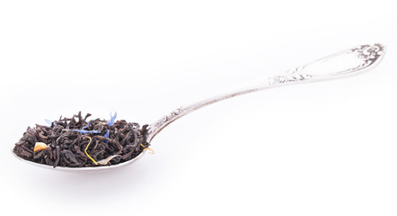 Earl grey tea with calendula, cornflowers in the silver spoon