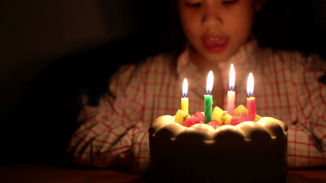 HD Dolly Asian girl blowing birthday cake candles