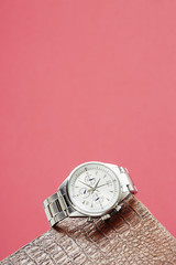 Luxury men's watch against colored background .