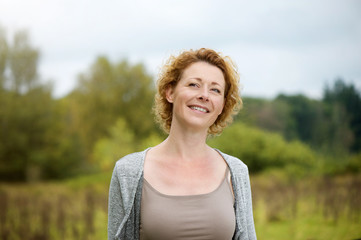 Beautiful middle aged woman smiling outdoors