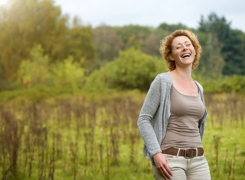 Beautiful woman laughing in the countryside