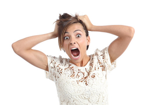 Front view of a scared woman screaming with hands on head