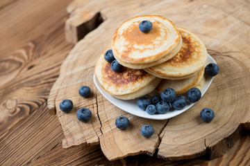 Pancakes with blueberries, rustic wooden background, studio shot