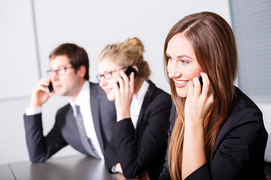 Business people having phonecall in meeting