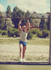 Ghetto street workout, vintage photo handsome man posing in urba