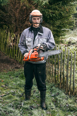 Professional gardener with chainsaw