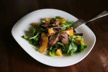 Salad with roasted duck breast and orange