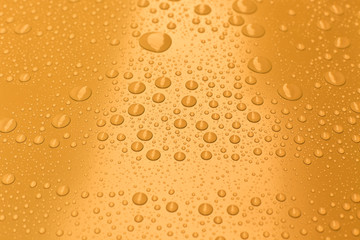 Water drops on bright yellow background