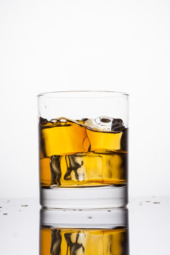 Whisky in glass on a white background