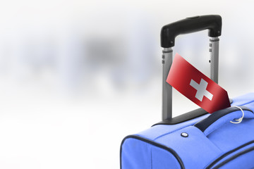 Destination Switzerland. Blue suitcase with flag.