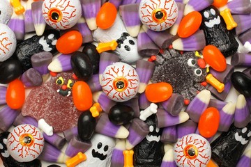 Fototapeta na wymiar Halloween background of mixed candies