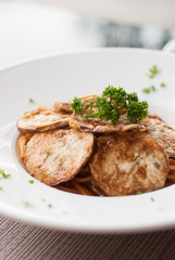 Spaghetti with a slice of grilled eggplant