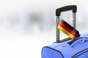 Destination Germany. Blue suitcase with flag.