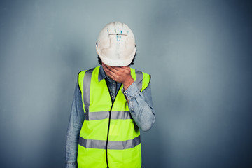 Fototapeta premium Engineer in high vis covering face