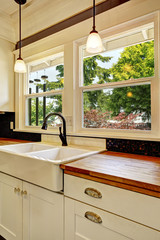 White kitchen cabinet with wooden counter top