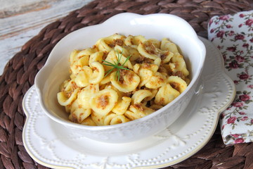 Italian pasta orecchiette with sausages and onions