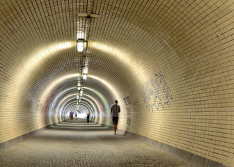 long tunnel in Prague with walking people