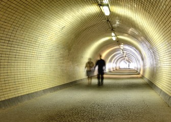 long tunnel with walking people