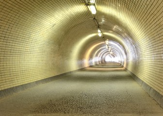 long empty tunnel with light at the end of the tunnel