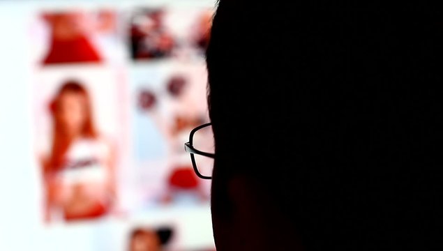 Man watching pictures of nude women in internet