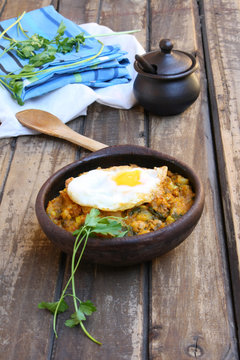 Pumpkin stew with fried egg on a outdoors table