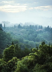 Fototapeta na wymiar Italian house in foggy hillside
