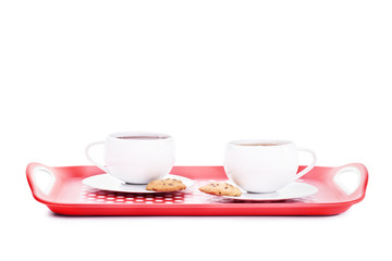 Two cups of tea with cookies on a platter