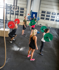 Trainers And Athletes In Weightlifting Class