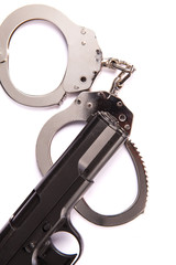 police handcuffs with a gun isolated on a white background