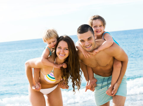 Family With Two Kids On Beach