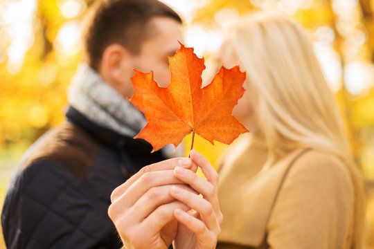 close up of couple kissing in autumn park