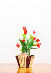 Red and White Rose in the mud Vase over Wood table against the W