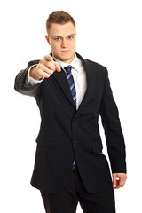 Young man in suit shows on you on isolate white background