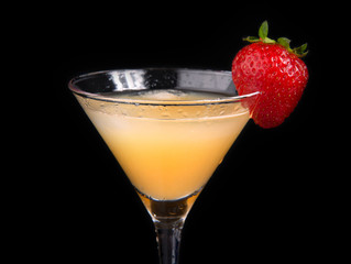 Yellow martini cocktail drink decorated with strawberry