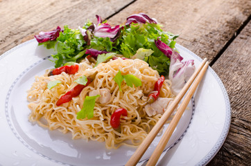 Chinese noodles with chicken and fresh salad