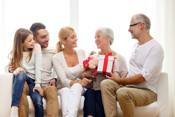 happy family with bunch and gift box at home