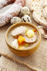 Portion of the sour rye soup made of soured rye flour and meat