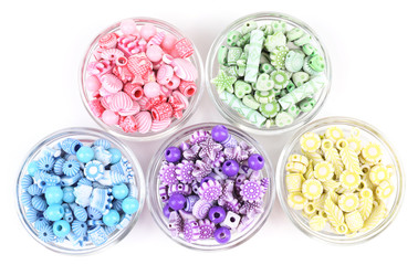 Beads in glass bowls isolated on white