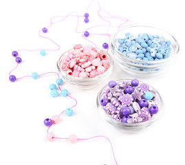 Beads in glass bowls isolated on white