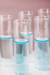 Test tubes with liquid on grey background