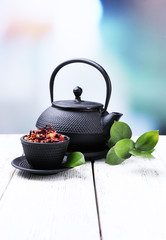 Obraz na płótnie Canvas Black teapot, bowl and tea